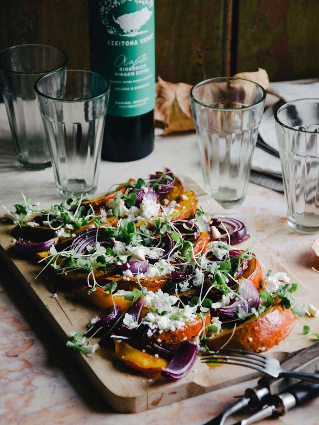 Baked pumpkin with feta cheese, red onion, and microgreens